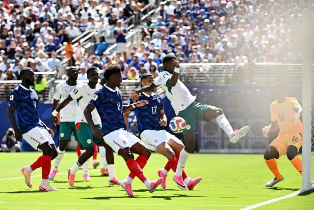 France's midfielder #08 Aurelien Tchouameni (C) and Senegal's forward #11 Nicolas Jackson (L) fight for the ball during of the 2026 World Cup Group I football match between France and Senegal at the New York/New Jersey Stadium in East Rutherford on June 16, 2026. (Photo by Jewel SAMAD / AFP)