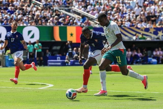 Senegal's forward #11 Nicolas Jackson and France's defender #04 Dayot Upamecano fight for the ball during the 2026 World Cup Group I football match between France and Senegal at the New York/New Jersey Stadium in East Rutherford on June 16, 2026.  (Photo by TIMOTHY A. CLARY / AFP)