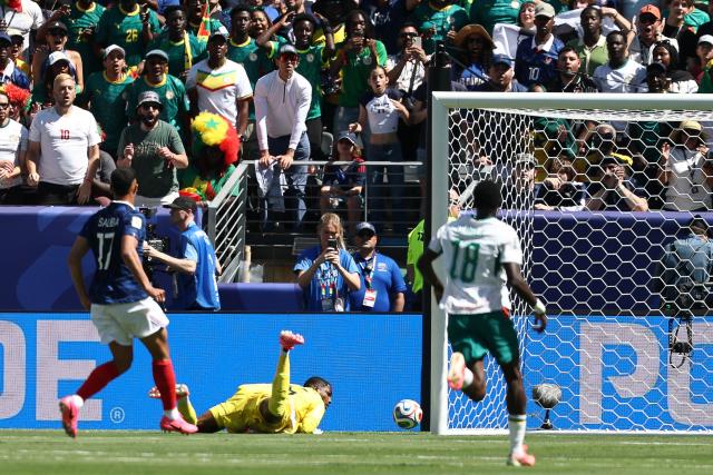 Senegal's goalkeeper #16 Edouard Mendy dives for the ball during the 2026 World Cup Group I football match between France and Senegal at the New York/New Jersey Stadium in East Rutherford on June 16, 2026.  (Photo by FRANCK FIFE / AFP)