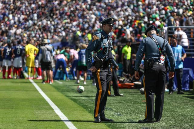 New Jersey State Police officers chat on the pitch during the 2026 World Cup Group I football match between France and Senegal at the New York/New Jersey Stadium in East Rutherford on June 16, 2026.  (Photo by FRANCK FIFE / AFP)