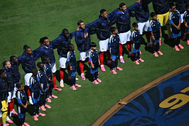 France's players sing the anthem ahead of the 2026 World Cup Group I football match between France and Senegal at the New York/New Jersey Stadium in East Rutherford on June 16, 2026. (Photo by Mauro PIMENTEL / AFP)