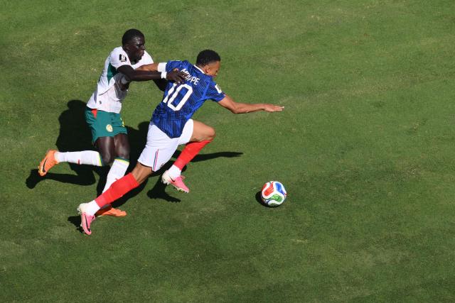 Senegal's defender #03 Kalidou Koulibaly and France's forward #10 Kylian Mbappe fight for the ball during the 2026 World Cup Group I football match between France and Senegal at the New York/New Jersey Stadium in East Rutherford on June 16, 2026. (Photo by Angela WEISS / AFP)