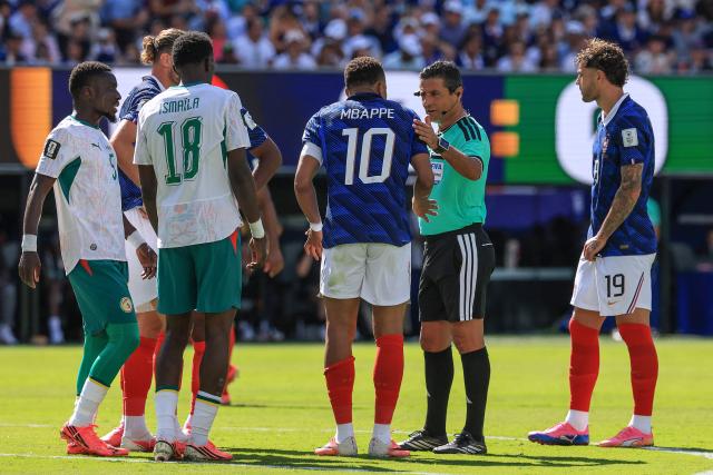 Australian referee Alireza Faghani talks to France's forward #10 Kylian Mbappe during the 2026 World Cup Group I football match between France and Senegal at the New York/New Jersey Stadium in East Rutherford on June 16, 2026.  (Photo by TIMOTHY A. CLARY / AFP)