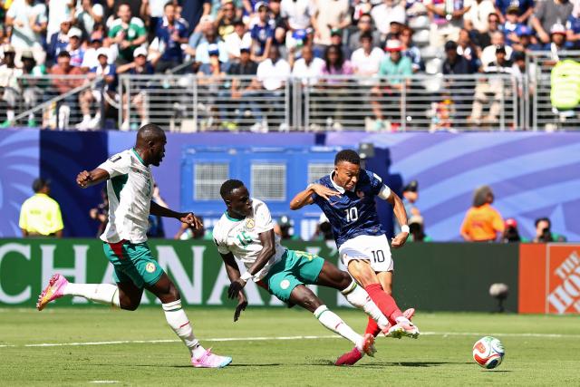 France's forward #10 Kylian Mbappe shoots past Senegal's defender #15 Krepin Diatta during the 2026 World Cup Group I football match between France and Senegal at the New York/New Jersey Stadium in East Rutherford on June 16, 2026.  (Photo by CHARLY TRIBALLEAU / AFP)