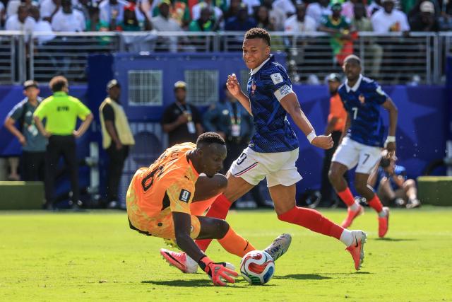 France's forward #10 Kylian Mbappe scores his team's first goal past Senegal's goalkeeper #16 Edouard Mendy during the 2026 World Cup Group I football match between France and Senegal at the New York/New Jersey Stadium in East Rutherford on June 16, 2026.  (Photo by TIMOTHY A. CLARY / AFP)
