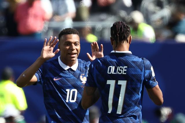 France's forward #10 Kylian Mbappe celebrates with teammate France's forward #11 Michael Olise after scoring his team's first goal during the 2026 World Cup Group I football match between France and Senegal at the New York/New Jersey Stadium in East Rutherford on June 16, 2026.  (Photo by FRANCK FIFE / AFP)