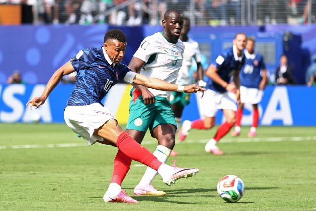 France's forward #10 Kylian Mbappe scores his team's first goal during the 2026 World Cup Group I football match between France and Senegal at the New York/New Jersey Stadium in East Rutherford on June 16, 2026.  (Photo by CHARLY TRIBALLEAU / AFP)
