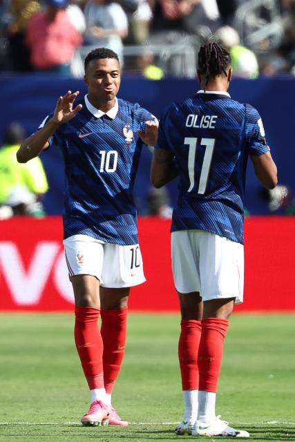 France's forward #10 Kylian Mbappe celebrates with teammate France's forward #11 Michael Olise after scoring his team's first goal during the 2026 World Cup Group I football match between France and Senegal at the New York/New Jersey Stadium in East Rutherford on June 16, 2026.  (Photo by FRANCK FIFE / AFP)