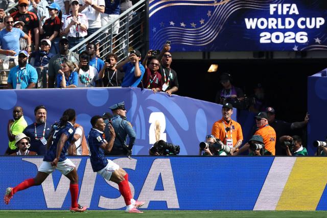 France's forward #10 Kylian Mbappe celebrates with teammate France's defender #05 Jules Kounde after scoring his team's first goal during the 2026 World Cup Group I football match between France and Senegal at the New York/New Jersey Stadium in East Rutherford on June 16, 2026.  (Photo by FRANCK FIFE / AFP)
