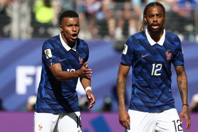 France's forward #10 Kylian Mbappe reacts next to forward #12 Bradley Barcola during the 2026 World Cup Group I football match between France and Senegal at the New York/New Jersey Stadium in East Rutherford on June 16, 2026.  (Photo by FRANCK FIFE / AFP)