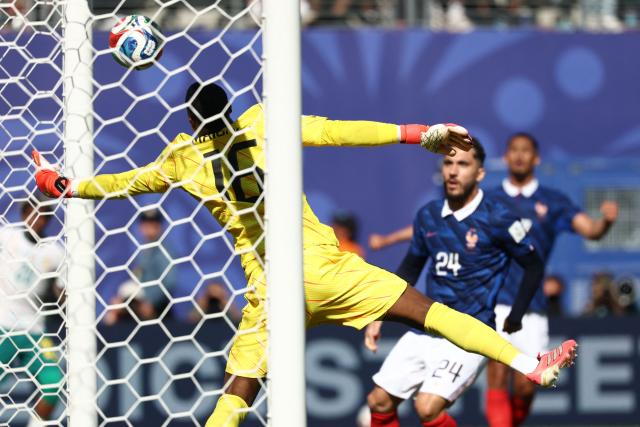 France's goalkeeper #16 Mike Maignan makes a save during the 2026 World Cup Group I football match between France and Senegal at the New York/New Jersey Stadium in East Rutherford on June 16, 2026.  (Photo by FRANCK FIFE / AFP)