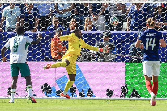 France's goalkeeper #16 Mike Maignan makes a save during the 2026 World Cup Group I football match between France and Senegal at the New York/New Jersey Stadium in East Rutherford on June 16, 2026.  (Photo by TIMOTHY A. CLARY / AFP)