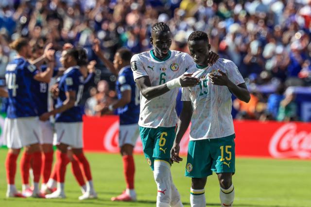 Senegal's midfielder #06 Pathe Ciss and defender #15 Krepin Diatta react after losing the 2026 World Cup Group I football match between France and Senegal at the New York/New Jersey Stadium in East Rutherford on June 16, 2026.  (Photo by TIMOTHY A. CLARY / AFP)