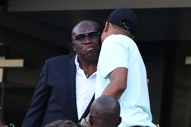 France's forward #10 Kylian Mbappe kisses his father Wilfried Mbappe after the 2026 World Cup Group I football match between France and Senegal at the New York/New Jersey Stadium in East Rutherford on June 16, 2026.  (Photo by Franck FIFE / AFP)