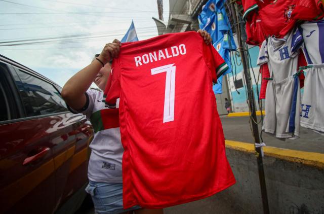 A street vendor displays a jersey bearing the name of Portuguese footballer Cristiano Ronaldo on a street in Tegucigalpa on June 16, 2026. (Photo by Johny Magallanes / AFP)