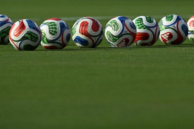 Official tournament balls are pictured at the pitch ahead of the 2026 World Cup Group J football match between Argentina and Algeria at the Kansas City Stadium in Kansas City on June 16, 2026.  (Photo by Roberto SCHMIDT / AFP)