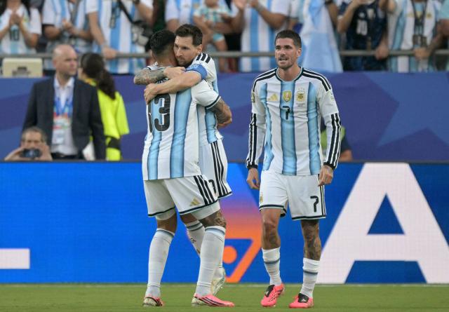 Argentina's forward #10 Lionel Messi celebrates with teammate defender #13 Cristian Romero scoring his team's first goal during the 2026 World Cup Group J football match between Argentina and Algeria at the Kansas City Stadium in Kansas City on June 16, 2026.  (Photo by JUAN MABROMATA / AFP)