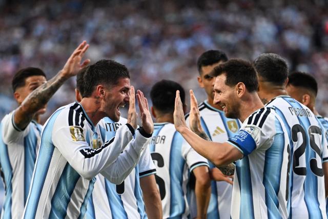 Argentina's forward #10 Lionel Messi celebrates with teammate midfielder #07 Rodrigo De Paul scoring his team's first goal during the 2026 World Cup Group J football match between Argentina and Algeria at the Kansas City Stadium in Kansas City on June 16, 2026.  (Photo by ROBERTO SCHMIDT / AFP)