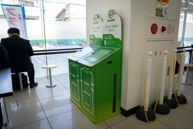This picture taken on May 13, 2026, shows recycling boxes for clothing, household goods and toys at a FamilyMart convenience store in Tokyo. Under a scorching sun in a Bangkok suburb, a whistle blows and shouts fill the air as dozens of shoppers rush into a warehouse bearing the sign: "Japanese Second-Hand Store". From bags and bicycles to surfboards and suitcases, the Japanese second-hand market is booming, with quality-conscious buyers in other Asian countries increasingly tapping into the circular economy trend. (Photo by Yuichi YAMAZAKI / AFP) / To go with "JAPAN-LIFESTYLE-ENVIRONMENT-RECYCLE,FOCUS' by Montira Rungjirajittranon with Kyoko Hasegawa