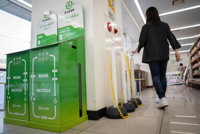 This picture taken on May 13, 2026, shows recycling boxes for clothing, household goods and toys at a FamilyMart convenience store in Tokyo. Under a scorching sun in a Bangkok suburb, a whistle blows and shouts fill the air as dozens of shoppers rush into a warehouse bearing the sign: "Japanese Second-Hand Store". From bags and bicycles to surfboards and suitcases, the Japanese second-hand market is booming, with quality-conscious buyers in other Asian countries increasingly tapping into the circular economy trend. (Photo by Yuichi YAMAZAKI / AFP) / To go with "JAPAN-LIFESTYLE-ENVIRONMENT-RECYCLE,FOCUS' by Montira Rungjirajittranon with Kyoko Hasegawa