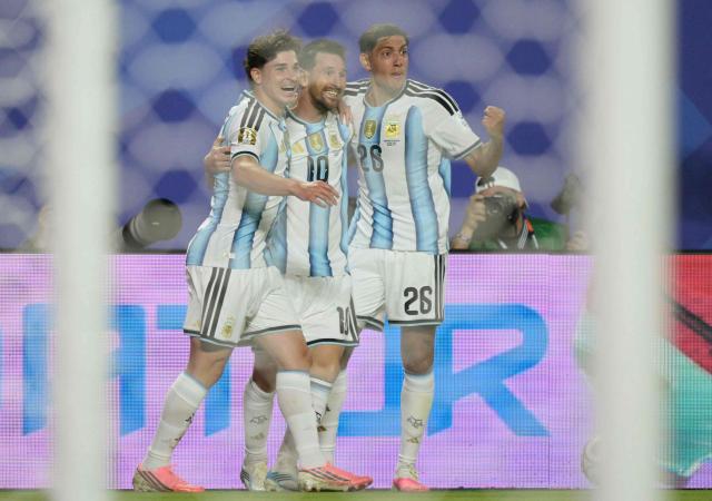Argentina's forward #10 Lionel Messi celebrates with teammates  forward #09 Julian Alvarez and defender #26 Nahuel Molina scoring his team's second goal during the 2026 World Cup Group J football match between Argentina and Algeria at the Kansas City Stadium in Kansas City on June 16, 2026.  (Photo by JUAN MABROMATA / AFP)