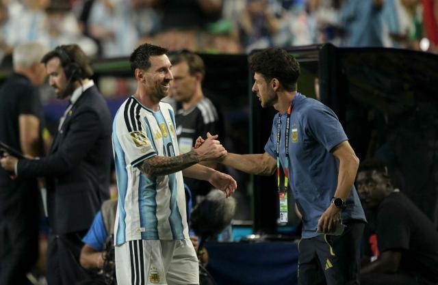 Argentina's forward #10 Lionel Messi greets assistant coach Pablo Aimar as he leaves the pitch during the 2026 World Cup Group J football match between Argentina and Algeria at the Kansas City Stadium in Kansas City on June 16, 2026.  (Photo by JUAN MABROMATA / AFP)