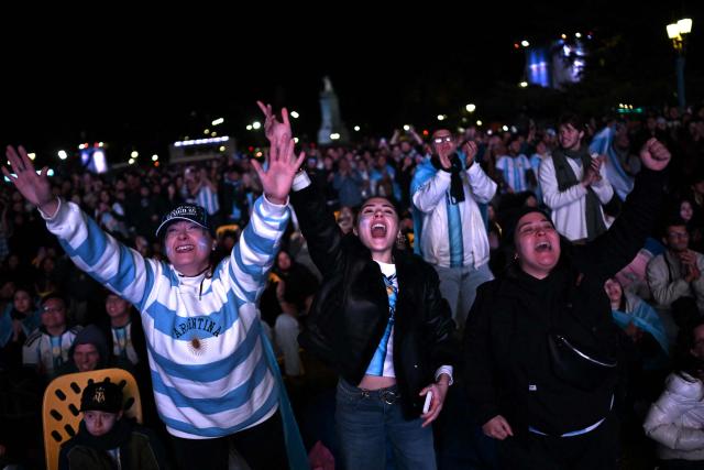 Argentina fans celebrate a goal scored by Argentina's forward Lionel Messi during the 2026 FIFA World Cup Group J football match between Argentina and Algeria as they watch it on a giant screen in Buenos Aires on June 16, 2026. (Photo by Luis ROBAYO / AFP)