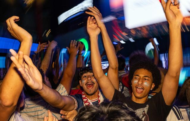 Argentina's fans celebrate at the end of the 2026 World Cup football tournament match between Argentina and Algeria at the Power & Light District in Kansas City, Missouri, on June 16, 2026. (Photo by Austin Johnson / AFP)