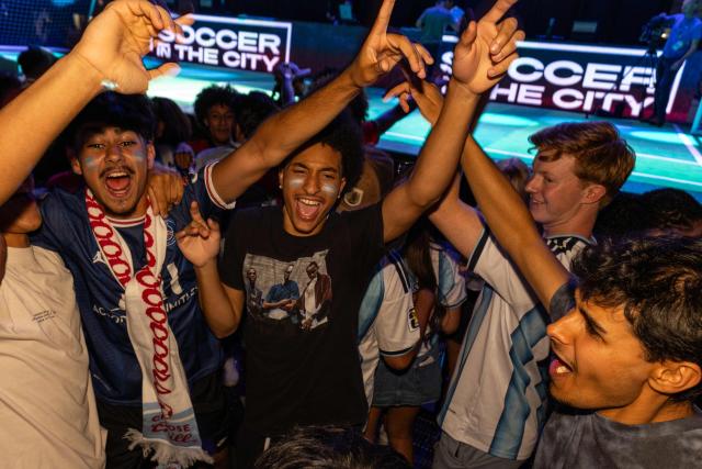 Football fans celebrate Argentina's victory in the 2026 World Cup football tournament match between Argentina and Algeria at the Power & Light District in Kansas City, Missouri, on June 16, 2026. (Photo by Austin Johnson / AFP)