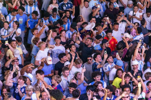 Football fans celebrate Argentina's third goal while watching the 2026 World Cup football tournament match between Argentina and Algeria at the Power & Light District in Kansas City, Missouri, on June 16, 2026. (Photo by Austin Johnson / AFP)
