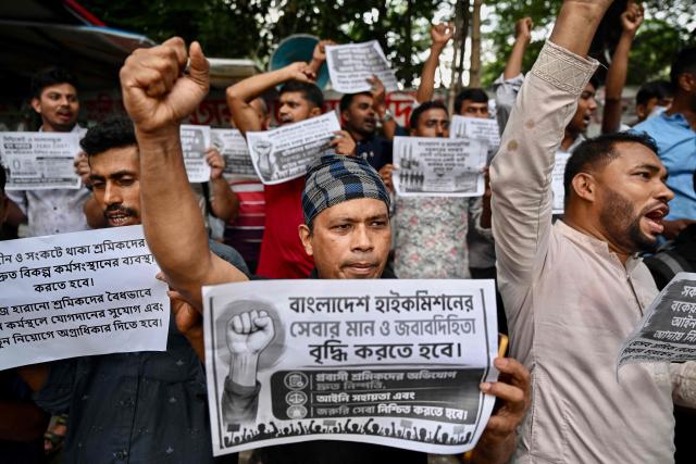Migrant workers and activists holding placards shout slogans during a protest demanding the implementation of a six-point charter, including safer and lower migration costs, in Dhaka on June 17, 2026. (Photo by Munir UZ ZAMAN / AFP)