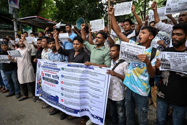 Migrant workers and activists holding placards shout slogans during a protest demanding the implementation of a six-point charter, including safer and lower migration costs, in Dhaka on June 17, 2026. (Photo by Munir UZ ZAMAN / AFP)