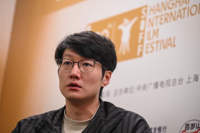 Chinese filmmaker Qiu Sheng takes part in an interview with AFP during the 28th Shanghai International Film Festival in Shanghai on June 17, 2026. (Photo by Jade GAO / AFP)
