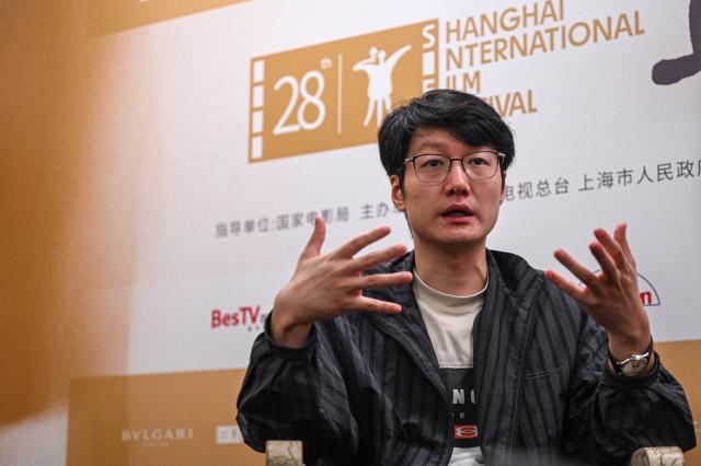 Chinese filmmaker Qiu Sheng takes part in an interview with AFP during the 28th Shanghai International Film Festival in Shanghai on June 17, 2026. (Photo by Jade GAO / AFP)