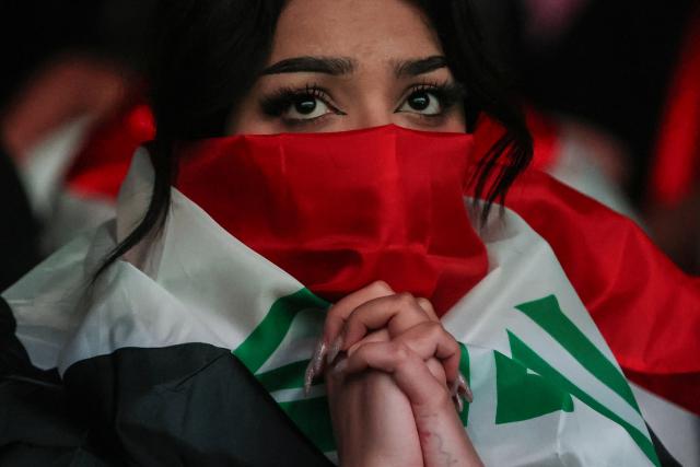 An Iraq football fan reacts as she watches the 2026 World Cup football tournament match between Iraq and Norway at a cafe in the Karrada district of Baghdad on June 17, 2026. Iraq's only other World Cup appearance came in 1986. (Photo by AHMAD AL-RUBAYE / AFP)