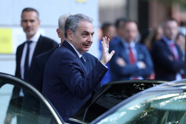 Spain's former Prime Minister Jose Luis Rodriguez Zapatero waves as he arrives to be questioned by a judge as part of an investigation for alleged influence peddling, at Madrid's Court on June 17, 2026. The case centres on the 53-million-euro state bailout of small airline Plus Ultra in 2021 and whether Zapatero used his influence to secure the money in exchange for commissions. (Photo by Thomas COEX / AFP)