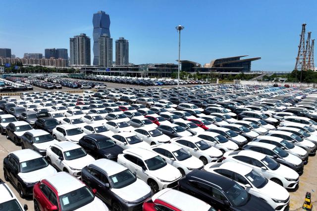 Chinese-made MG cars are seen on a dock before being loaded onto a ship for export, at the port in Lianyungang, in China’s eastern Jiangsu province on June 17, 2026. (Photo by CN-STR / AFP) / China OUT