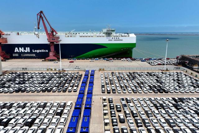 Cars and vans are seen on a dock before being loaded onto a ship for export, at the port in Lianyungang, in China’s eastern Jiangsu province on June 17, 2026. (Photo by CN-STR / AFP) / China OUT