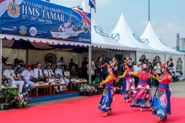 Dancers perform a welcome dance upon the arrival of the British Royal Navy (HMS) Tamar patrol vessel at Tanjung Priok Port in Jakarta on June 17, 2026. (Photo by BAY ISMOYO / AFP)