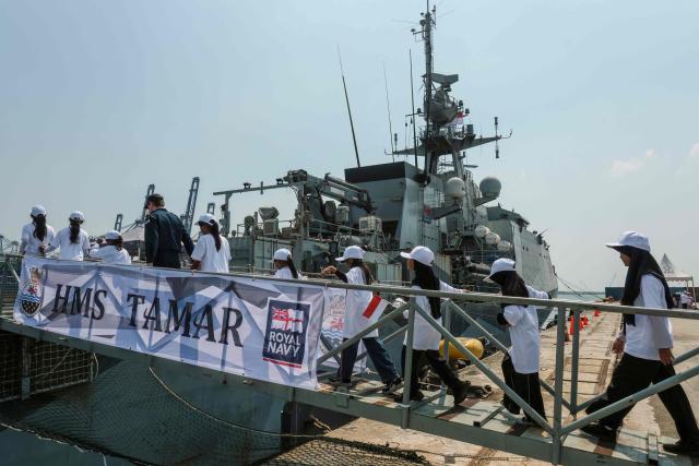 Indonesian primary school children visit the British Royal Navy (HMS) Tamar patrol vessel at Tanjung Priok Port in Jakarta on June 17, 2026. (Photo by BAY ISMOYO / AFP)
