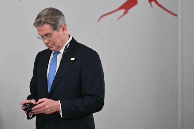 US Secretary of Treasury Scott Bessent reacts as he arrives ahead of a morning work meeting to “revive balanced, inclusive, and sustainable economic growth for the benefit of all” in the presence of the G7 countries, partner countries, the International Monetary Fund, and the OECD, as part of the G7 summit, in Evian, eastern France, on June 17, 2026. G7 leaders will discuss on June 17, 2026, the security risks posed by AI and social media on the last day of a summit dominated by US the President, before host French President  dines with his US counterpart at the Palace of Versailles. The three-day summit of the leaders of Canada, France, Germany, Italy, Japan,B ritain and the United States has focused intensely on the US' deal to end the war with Iran and efforts to pressure Russia into brokering peace with Ukraine. (Photo by Mandel NGAN / AFP)