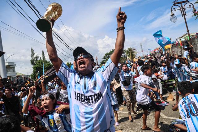 Football fans celebrate Argentina's goal against Algeria as they watch the FIFA World Cup 2026 group J match on a giant screen at Fort Oranje in Ternate, North Maluku, on June 16, 2026. (Photo by AZZAM RIZQULLAH / AFP)