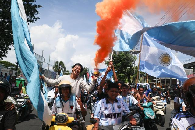 Football fans celebrate on motorcycles following Argentina's victory over Algeria at the FIFA World Cup 2026, in Ternate, North Maluku, on June 16, 2026. (Photo by AZZAM RIZQULLAH / AFP)