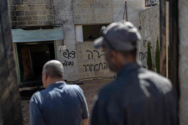 A Palestinian man inspects the damage in a mosque reportedly burnt by Israeli settlers over night, with Hebrew script graffitis on the walls, in the Israeli occupied West Bank village of Jiljlia, just north of the West bank city of Ramallah on June 17, 2026. Expanding Israeli settlements has been a policy under successive Israeli governments but has accelerated under the current prime minister's coalition, which is backed by far-right allies. More than 500,000 Israelis now live in the West Bank. excluding east Jerusalem, in settlements that are illegal under international law, among some three million Palestinians. (Photo by ilia YEFIMOVICH / AFP)
