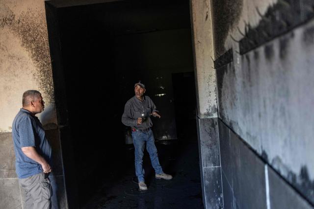 Palestinian men inspect the damage inside a mosque reportedly burnt by Israeli settlers over night, in the Israeli occupied West Bank village of Jiljlia, just north of the West Bank city of Ramallah on June 17, 2026. Expanding Israeli settlements has been a policy under successive Israeli governments but has accelerated under the current prime minister's coalition, which is backed by far-right allies. More than 500,000 Israelis now live in the West Bank. excluding east Jerusalem, in settlements that are illegal under international law, among some three million Palestinians. (Photo by ilia YEFIMOVICH / AFP) / 