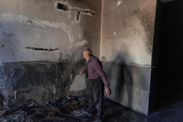 A Palestinian man inspects the damage inside a mosque reportedly burnt by Israeli settlers over night, in the Israeli occupied West Bank village of Jiljlia, just north of the West Bank city of Ramallah on June 17, 2026. Expanding Israeli settlements has been a policy under successive Israeli governments but has accelerated under the current prime minister's coalition, which is backed by far-right allies. More than 500,000 Israelis now live in the West Bank. excluding east Jerusalem, in settlements that are illegal under international law, among some three million Palestinians. (Photo by ilia YEFIMOVICH / AFP) / 