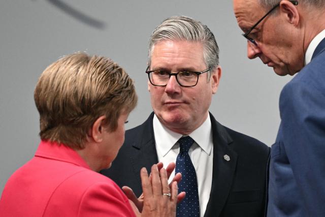 TOPSHOT - Britain's Prime Minister Keir Starmer (c) reacts as he speaks with IMF Managing Director Kristalina Georgieva (L) and Germany’s Chancellor Friedrich Merz ahead of a morning work meeting to “revive balanced, inclusive, and sustainable economic growth for the benefit of all” in the presence of the G7 countries, partner countries, the International Monetary Fund, and the OECD, as part of the G7 summit, in Evian, eastern France, on June 17, 2026. G7 leaders will discuss on June 17, 2026, the security risks posed by AI and social media on the last day of a summit dominated by US the President, before host French President  dines with his US counterpart at the Palace of Versailles. The three-day summit of the leaders of Canada, France, Germany, Italy, Japan,B ritain and the United States has focused intensely on the US' deal to end the war with Iran and efforts to pressure Russia into brokering peace with Ukraine. (Photo by Mandel NGAN / POOL / AFP)