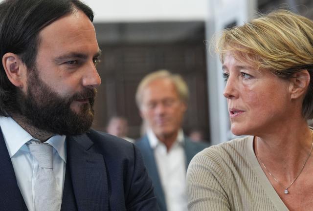Defendant, German entrepreneur and gastronomer Christina Block (R) sits next to her lawyer Ingo Bott (L), while former television presenter and sports journalist Gerhard Delling is seen in the background, prior to the continuation of the trial over alleged child abduction at the Criminal Court building in Hamburg, northern Germany, on June 17, 2026. The public prosecutor's office accuses Block, heiress of a steakhouse chain, of ordering the abduction of her daughter, born in 2010, and her son, born in 2013. According to the indictment, the background to this is an escalating custody dispute over many years between Block and her former husband, who have four children together. (Photo by Marcus Brandt / POOL / AFP)