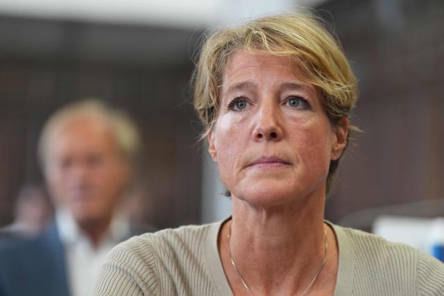 Defendant, German entrepreneur and gastronomer Christina Block is seated, while former television presenter and sports journalist Gerhard Delling is seen in the background, prior to the continuation of the trial over alleged child abduction at the Criminal Court building in Hamburg, northern Germany, on June 17, 2026. The public prosecutor's office accuses Block, heiress of a steakhouse chain, of ordering the abduction of her daughter, born in 2010, and her son, born in 2013. According to the indictment, the background to this is an escalating custody dispute over many years between Block and her former husband, who have four children together. (Photo by Marcus Brandt / POOL / AFP)