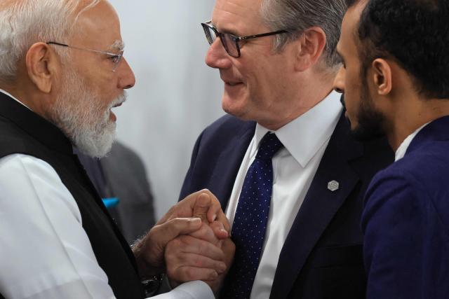 India's Prime Minister Narendra Modi (L) speaks with Britain's Prime Minister Keir Starmer ahead of a morning work meeting to “revive balanced, inclusive, and sustainable economic growth for the benefit of all” in the presence of the G7 countries, partner countries, the International Monetary Fund, and the OECD, as part of the G7 summit, in Evian, eastern France, on June 17, 2026. G7 leaders will discuss on June 17, 2026, the security risks posed by AI and social media on the last day of a summit dominated by US the President, before host French President  dines with his US counterpart at the Palace of Versailles. The three-day summit of the leaders of Canada, France, Germany, Italy, Japan,B ritain and the United States has focused intensely on the US' deal to end the war with Iran and efforts to pressure Russia into brokering peace with Ukraine. (Photo by Ludovic MARIN / AFP)